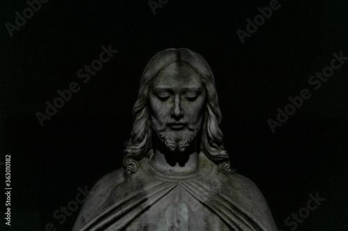 Statue of Jesus in front of church at nightime in Bogota, New Jersey photo