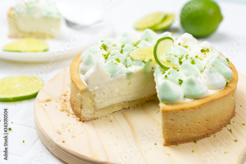 key lime cheese tart with whipping cream on the table