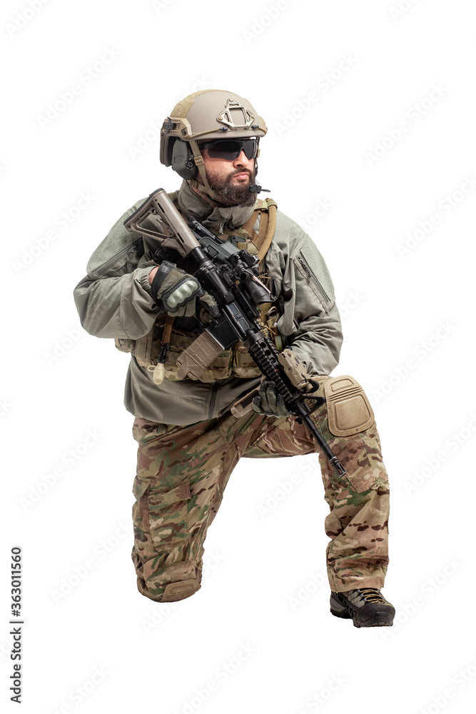 American soldier in military equipment with a rifle attacks on a white background, a commando with weapons in uniform, a ranger in action