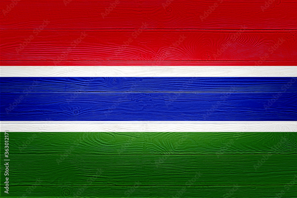 Gambia flag painted on old wood plank background. Brushed wooden board texture. Wooden texture background flag of Gambia. Gambia flag painted on old wood plank background. Brushed wooden board texture. Wooden texture background flag of Gambia.