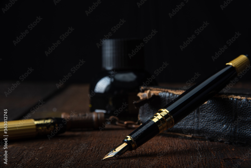 Fountain pen in an old rustic arrangement, selective focus Fountain pen in an old rustic arrangement, selective focus