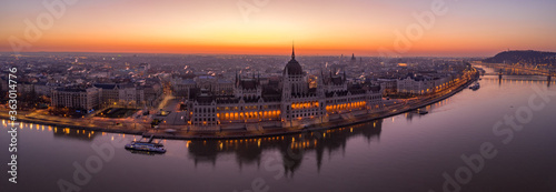 Panoramic aerial drone shot of Hungarian Parliament lights off before sunrise in Budapest dawn