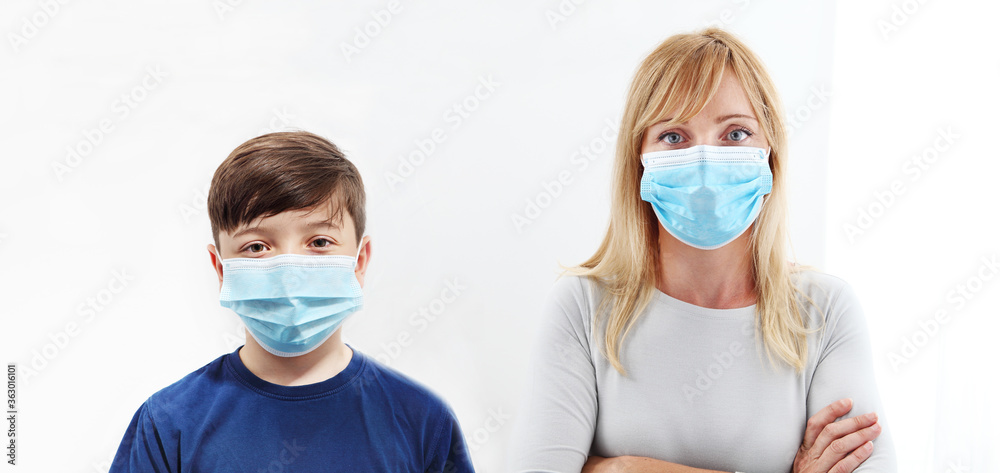 Child and Woman in a Medical Mask. Close-up portrait with a surgical mask on face isolated on white background, corona virus covid 19 protection