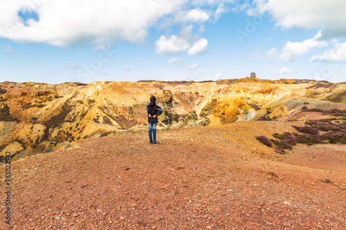 Small boy admiring the landscape of stony mountain, Parys Mountain