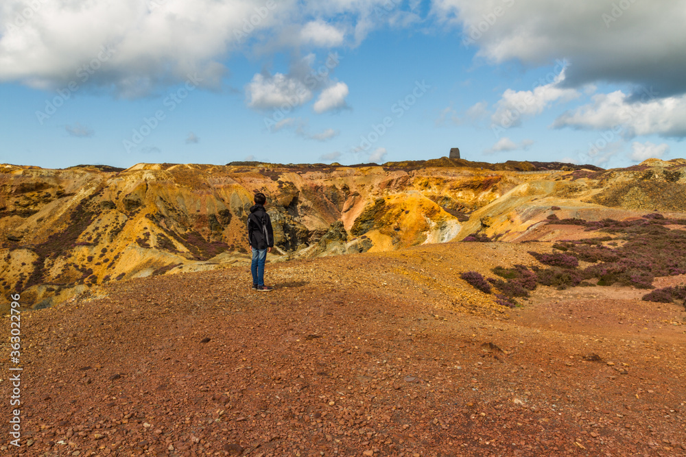 Small boy admiring the landscape of stony mountain, Parys Mountain. Small boy admiring the landscape of stony mountain, Parys Mountain.