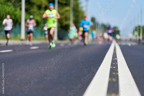 Runners on city road. photo