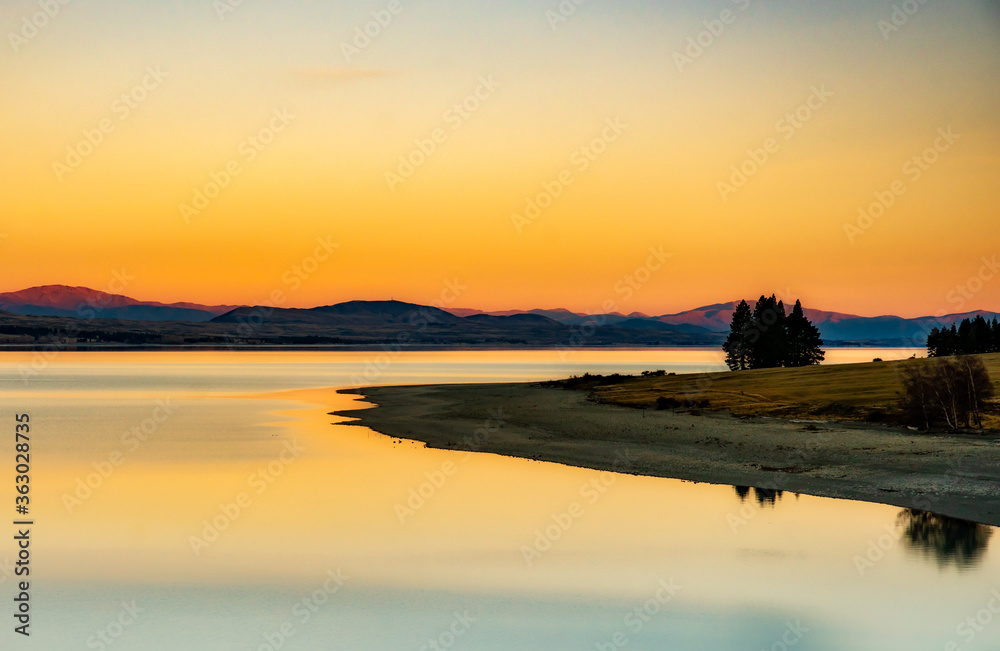 Stunning calm waters of Lake Pukaki at sunset on the way back from walking the Hooker Valley track in Aoraki Mount Cook National Park Stunning calm waters of Lake Pukaki at sunset on the way back from walking the Hooker Valley track in Aoraki Mount Cook National Park