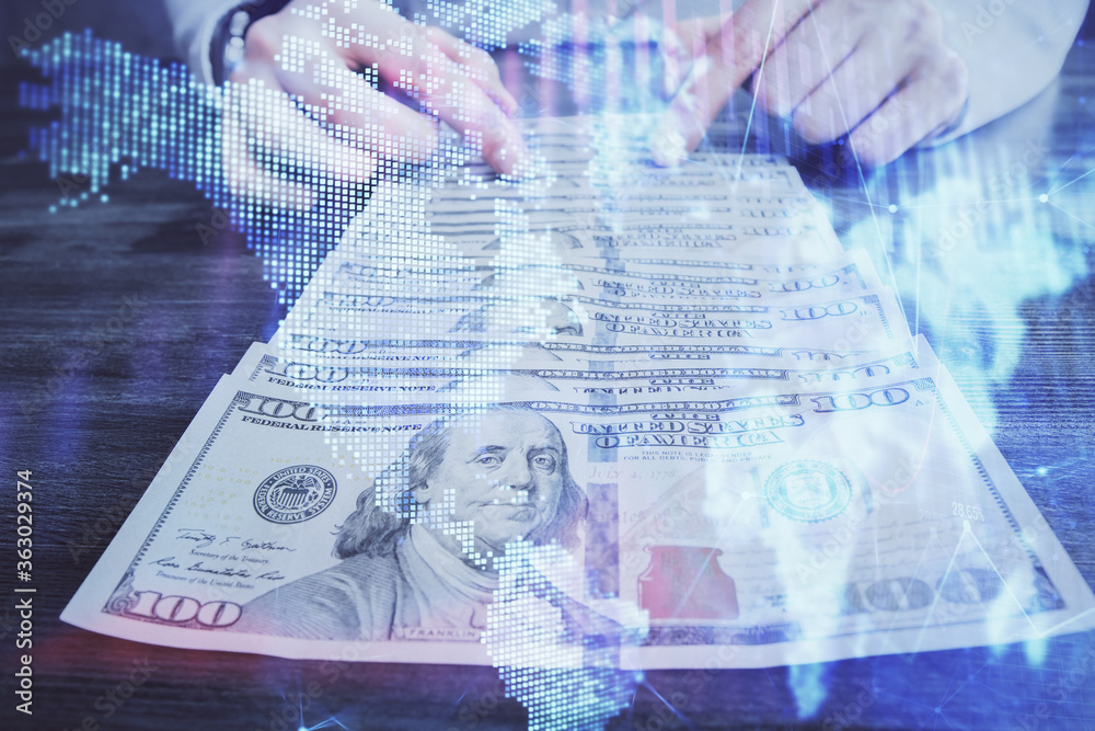 Multi exposure of forex graph drawing hologram and USA dollars bills and man hands. Technical Analysis concept. Multi exposure of forex graph drawing hologram and USA dollars bills and man hands. Technical Analysis concept.