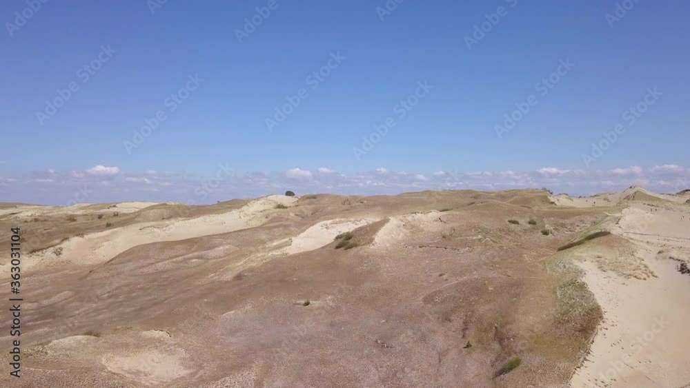 Breathtaking aerial shot of the Grey Dunes on the Curonian Split in Lithuania, revealing the Curonian Lagoon. Breathtaking aerial shot of the Grey Dunes on the Curonian Split in Lithuania, revealing the Curonian Lagoon.