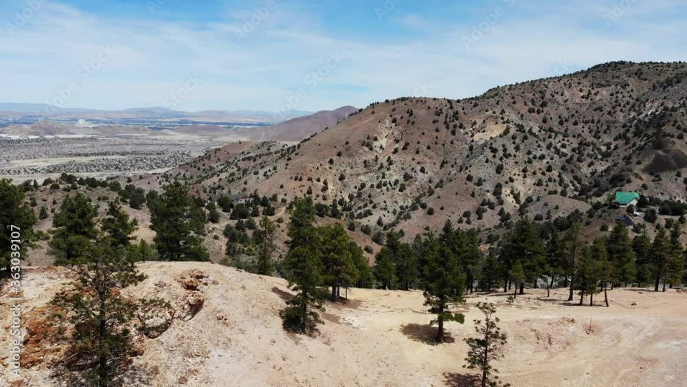 Flyover desert mountain and trees toward city of Reno. Flyover desert mountain and trees toward city of Reno.