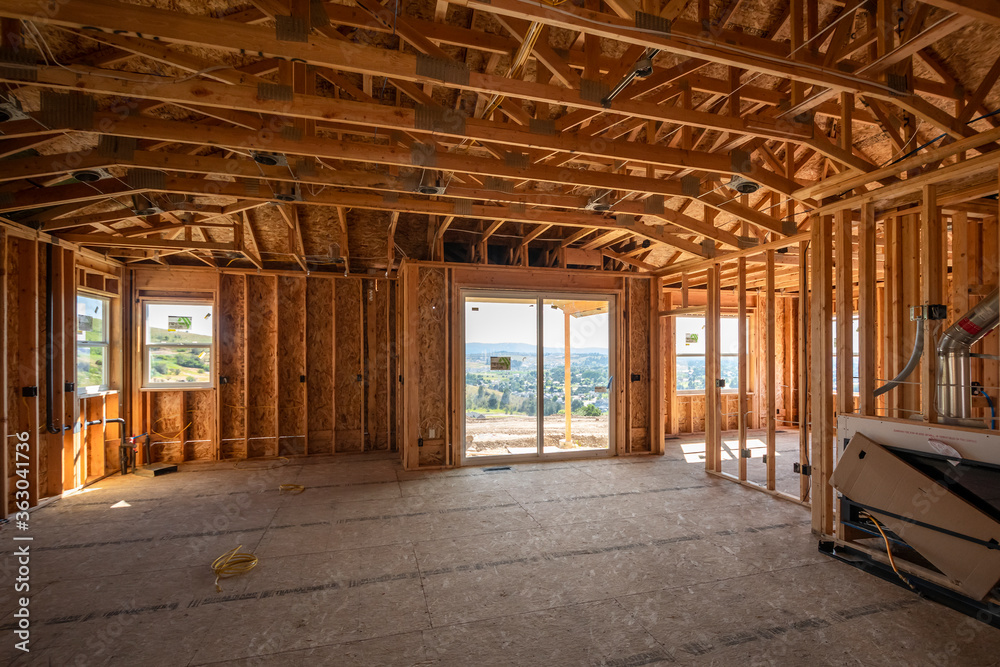 A new luxury home being built on a hilltop with views visible through the framed windows in Spokane, Washington