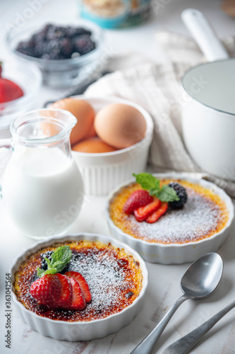 Fototapeta Naklejka Na Ścianę i Meble -  creme brulee with fruits and mint on white background