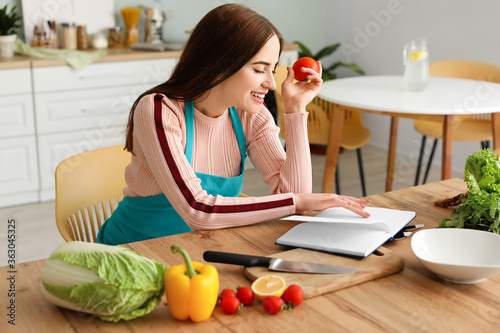 Young woman with recipe boo...