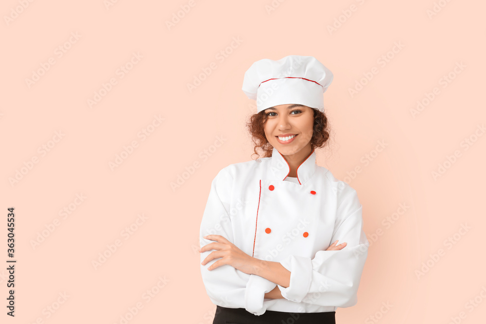 Female African-American chef on color background Female African-American chef on color background