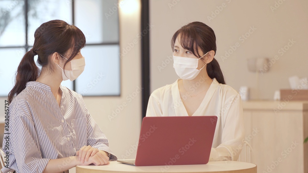 マスクを着用して打ち合わせをする女性