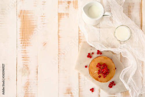 Sweet pancakes with berries on table