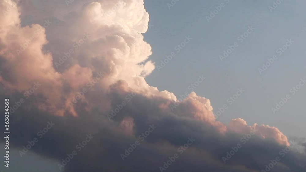 Large evening sunset stratocumulus clouds after a rain storm moving across the light sky. Footage is sped up with a stationed camera. Large evening sunset stratocumulus clouds after a rain storm moving across the light sky. Footage is sped up with a stationed camera.