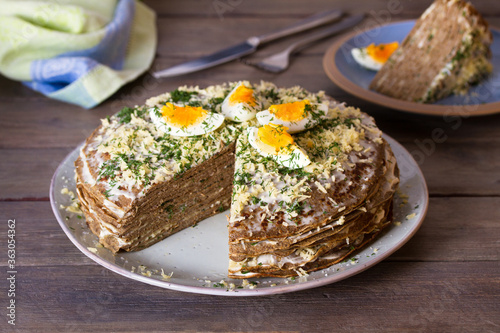 Layered liver cake with cheese, mayonnaise and dill