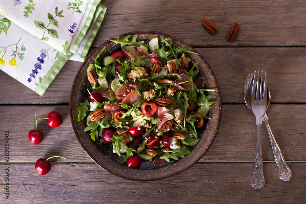 Strawberry and cured ham salad with gorgonzola cheese. Summer salad. View from above, top studio shot Strawberry and cured ham salad with gorgonzola cheese. Summer salad. View from above, top studio shot