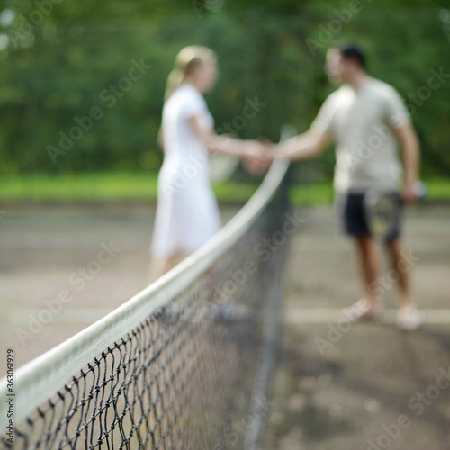 Couple shaking hands after the tennis match © ImageHit