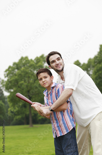 Father and son playing baseball © ImageHit