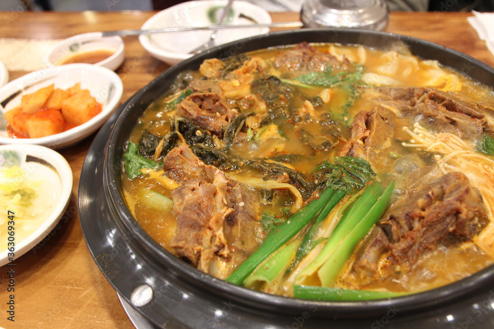 Korean pork bone soup with potato (Gamjatang) and vegetables at at Korean restaurant, Seoul, South Korea