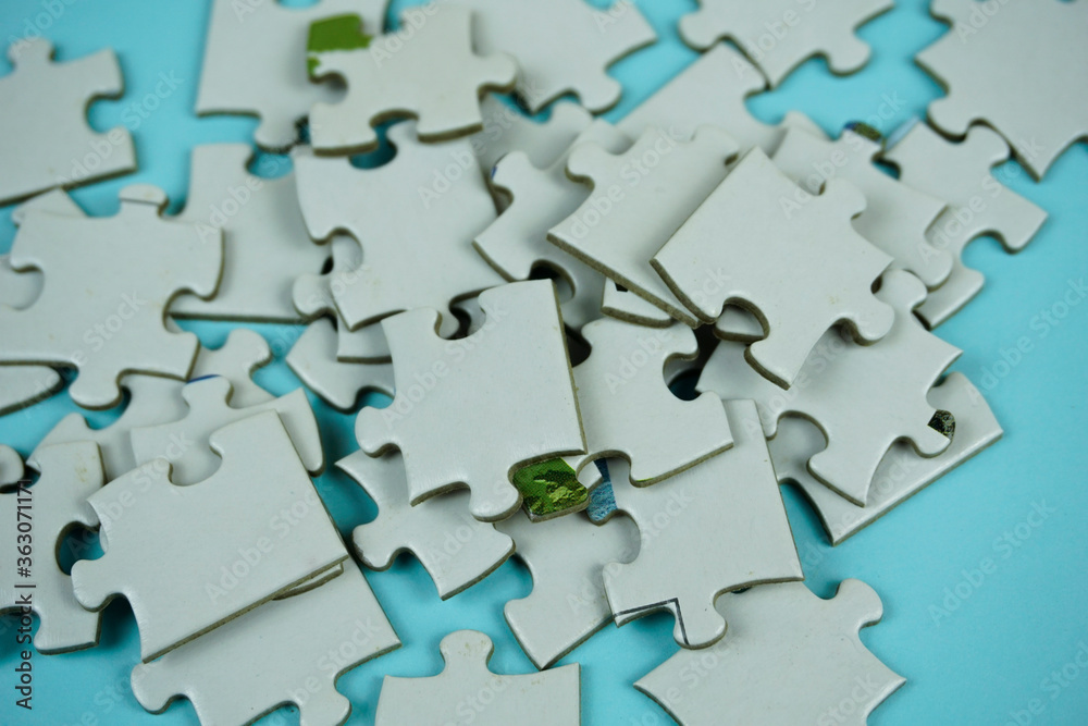 random white jigsaw puzzle incomplete concept on blue background random white jigsaw puzzle incomplete concept on blue background