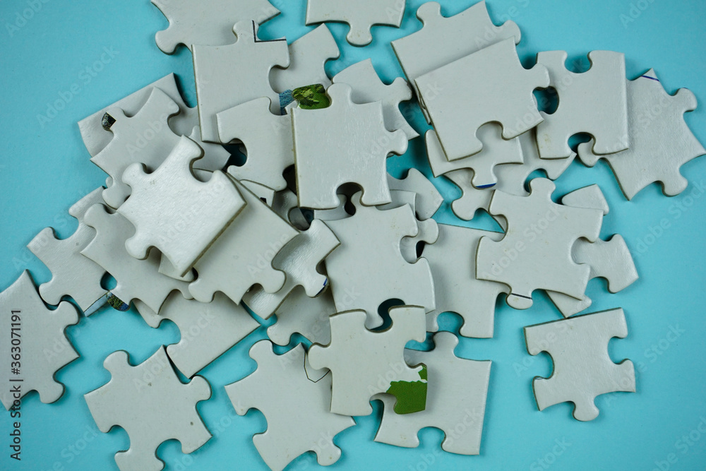random white jigsaw puzzle incomplete concept on blue background random white jigsaw puzzle incomplete concept on blue background