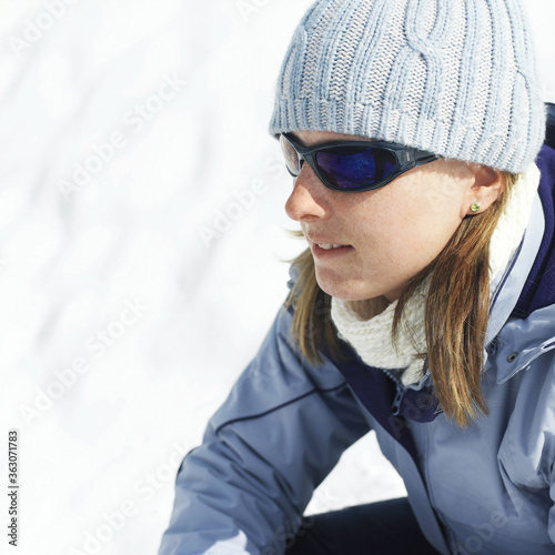 Woman in warm clothing and sunglasses