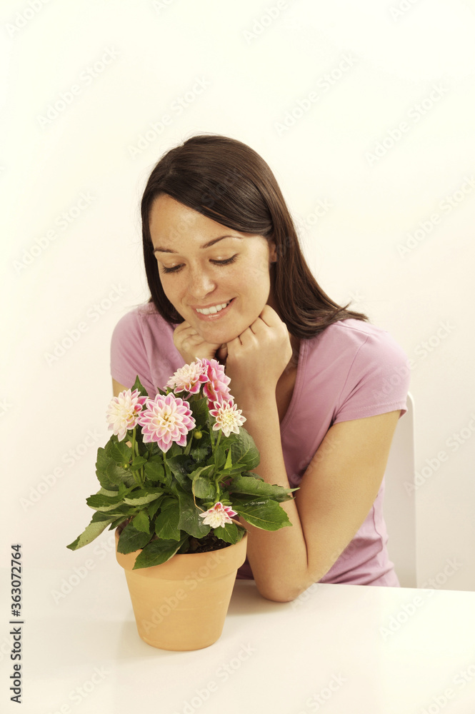 Woman admiring a potted flower