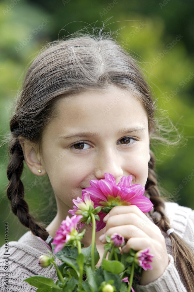 Girl smelling flowers Girl smelling flowers