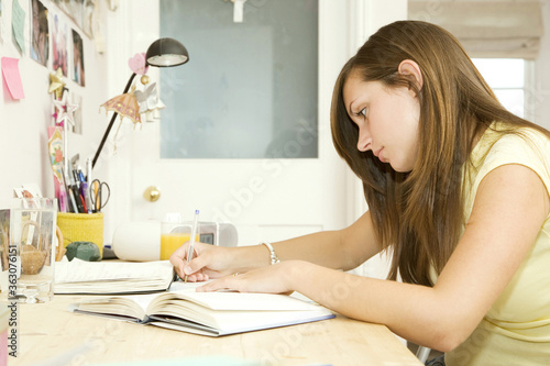 Girl doing assignment in her room