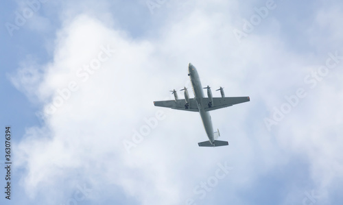 Turboprop aircraft flying through the sky at low altitude