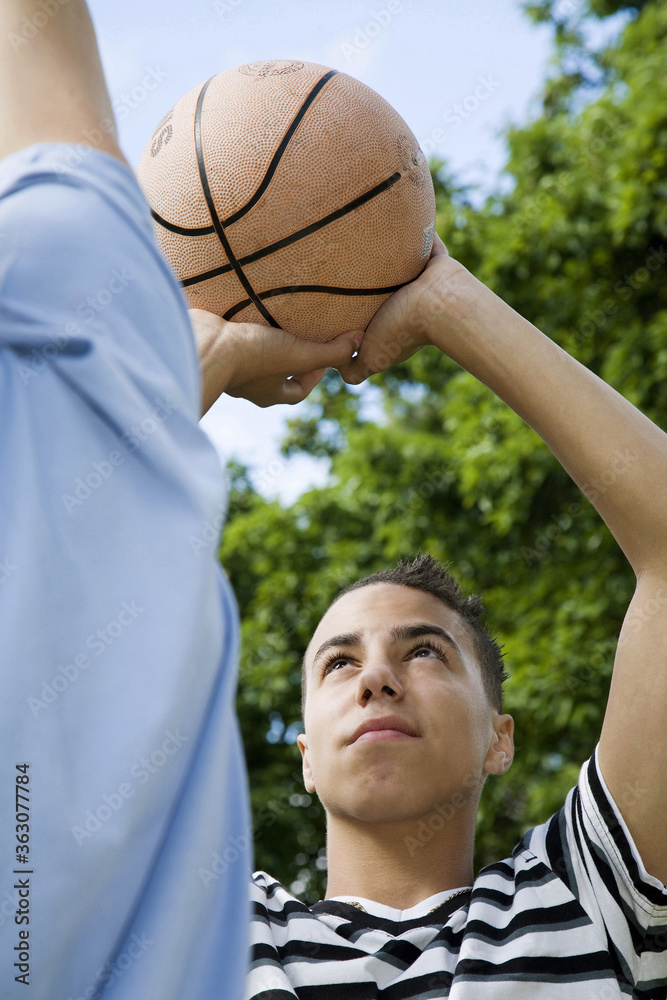 Boys playing basketball in the park