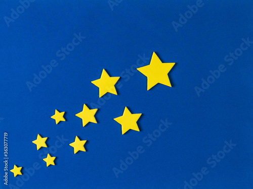 Image of paper stars on a blue background.