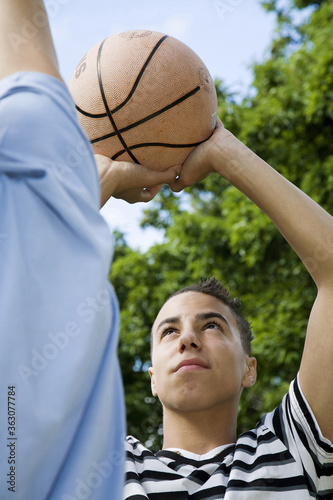 Boys playing basketball in the park