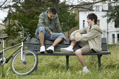 Boys sitting on the bench talking