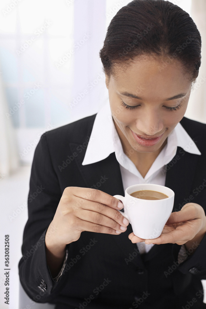 Businesswoman enjoying a cup of coffee Businesswoman enjoying a cup of coffee