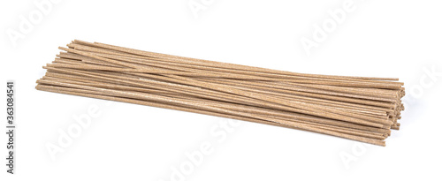 Dried raw japanese soba noodle sticks isolated on a white background.