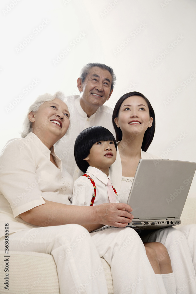 Fototapeta premium Boy and woman together with senior couple smiling while looking up