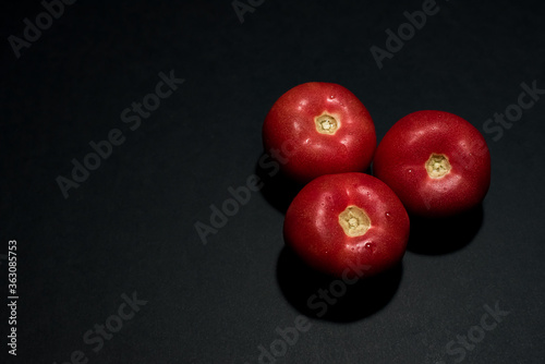  Fresh red tomatoes on a black table