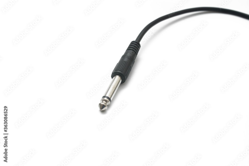 Close up the 6.3mm mono connector commonly used for connecting a guitar to an amplifier over white background. Close up the 6.3mm mono connector commonly used for connecting a guitar to an amplifier over white background.