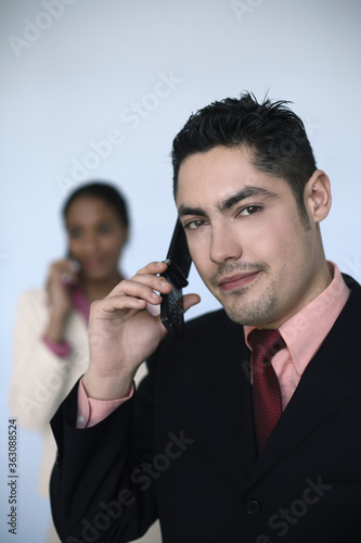 Businessman and businesswoman talking on the phone