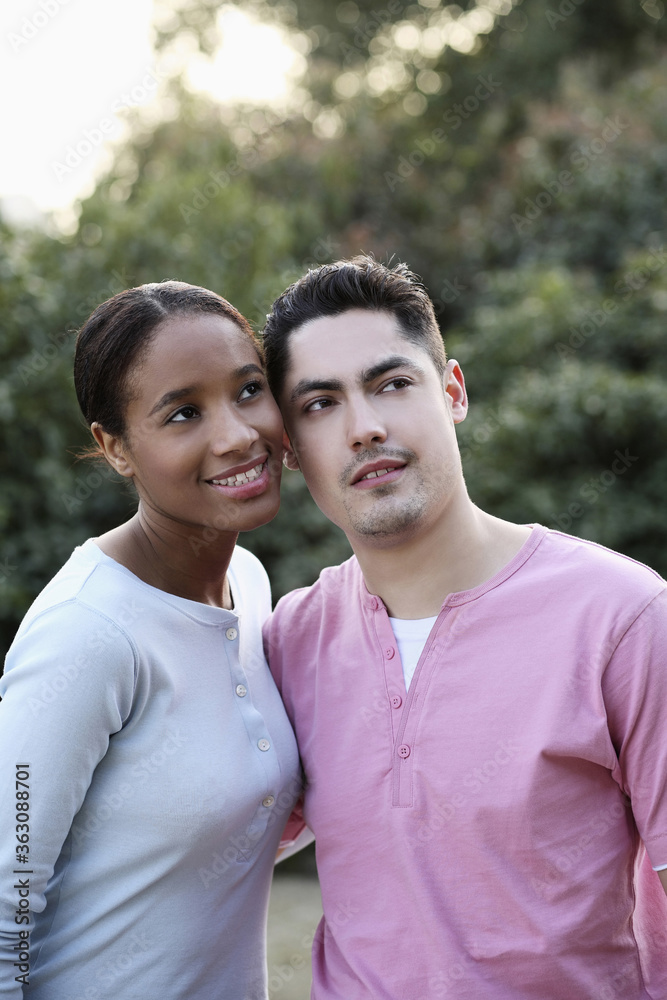 Man and woman smiling while looking away