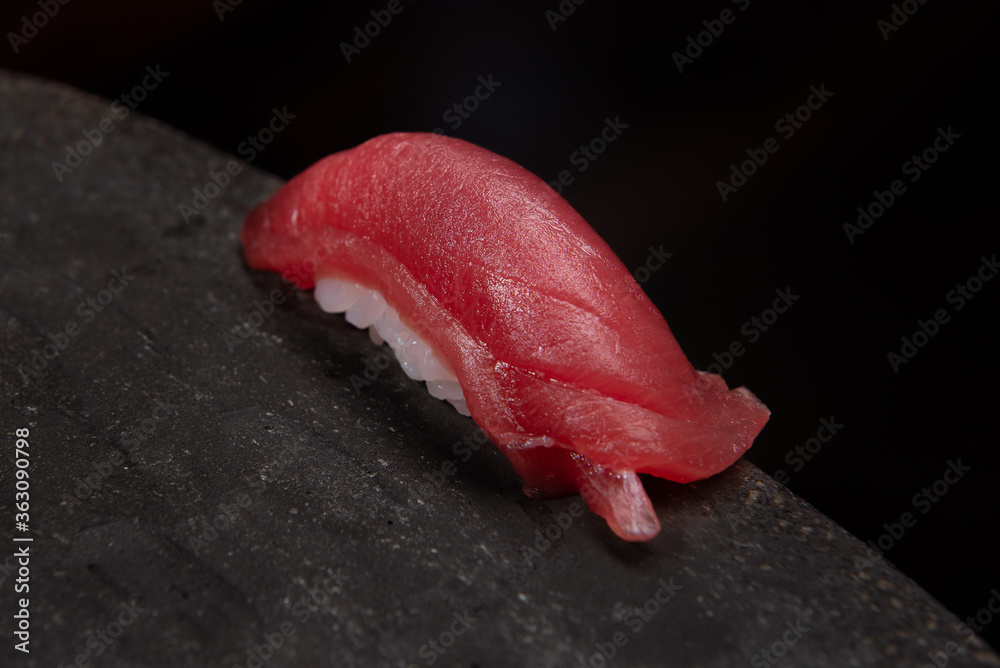 fine maguro shutoro nigiri sushi on stone with black background fine maguro shutoro nigiri sushi on stone with black background