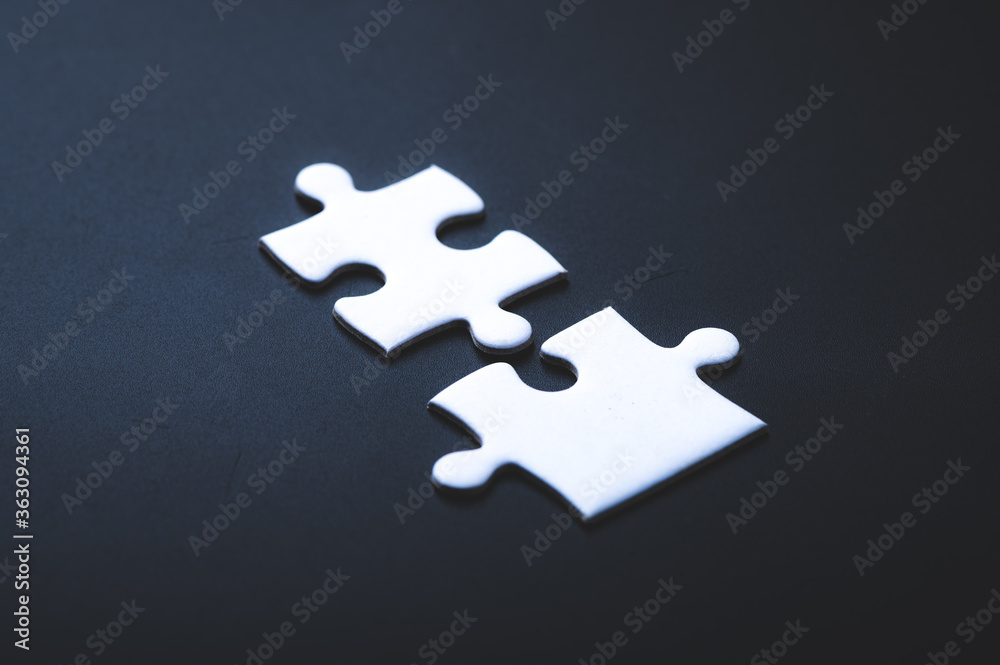 Two pieces of jigsaw puzzle or autism puzzle piece symbol, business partner concept Two pieces of jigsaw puzzle or autism puzzle piece symbol, business partner concept