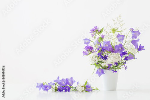 wild flowers in vase on white background