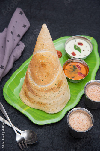 Dosa, ghee roast with coconut chutney  and sambar popular South Indian Breakfast, Kerala, Tamil Nadu India. Top view of Masala dosa, a type of pancake stuffed with potato and tomato curry side dish. photo