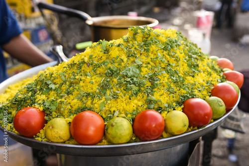 Poha or onion pohe  and fresh guava juice spicy popular traditional Indian breakfast dish Jaipur, Rajasthan, India. Top view of recipe made with rice flakes, beaten rice and vegetables. photo