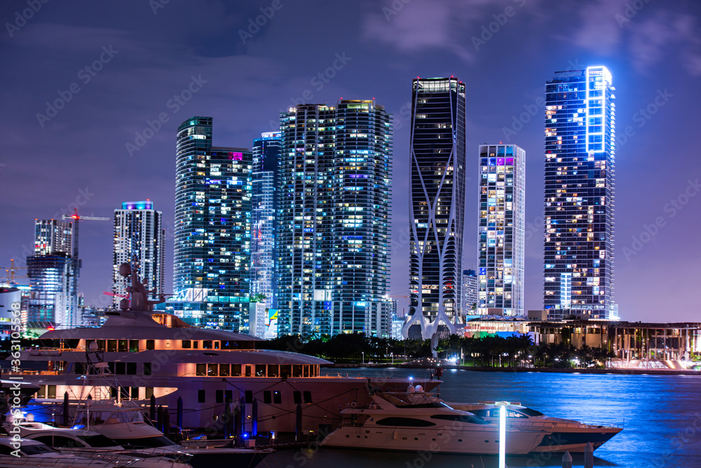 Miami south beach street view with water reflections at night. Miami downtown.